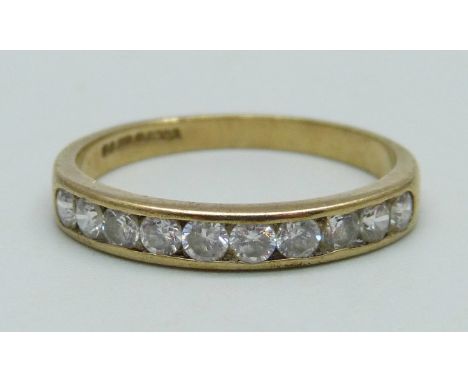 A 9ct gold ring set with ten white stones, 1.9g, R 