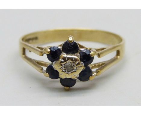 A 9ct gold cluster ring set with a small central diamond and blue stones, 1.3g, K 