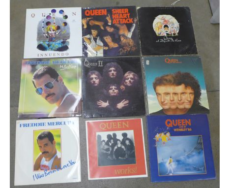 A collection of twenty Queen and Freddie Mercury LP records and 12" singles and a print of Freddie Mercury 