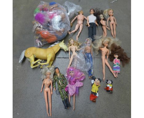 A box of vintage Barbie dolls, vintage Trolls, Action Man and a model horse