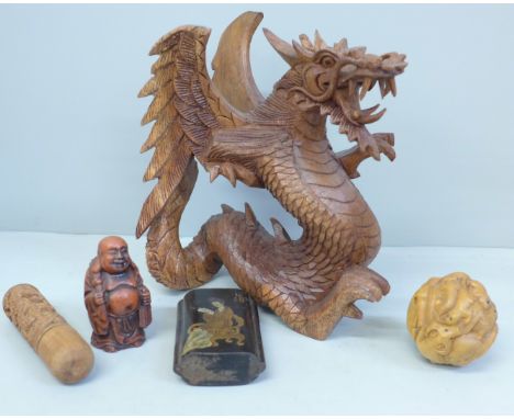 A Chinese carved zodiac ball netsuke, Japanese three section hand painted box, a carved letter stamp, carved model of a drago