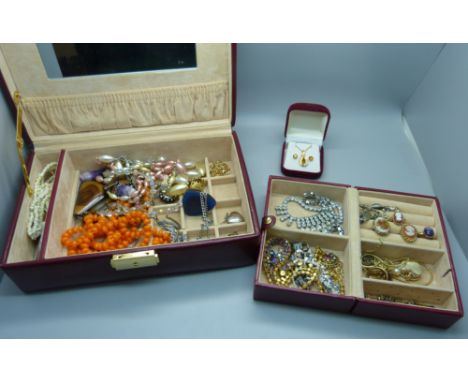 A case of costume jewellery including tigers eye and amethyst quartz pendants 