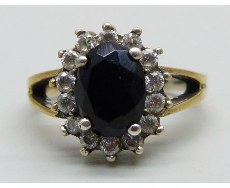 A silver gilt cluster ring set with a a black stone and cubic zirconia halo, M 