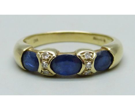 A 14ct gold ring set with three sapphires and six diamonds, 4.4g, R 