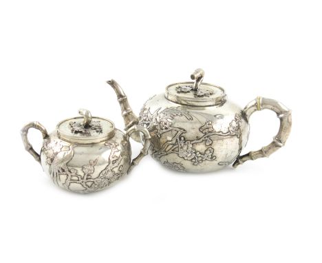 λA Chinese silver teapot and sugar bowl, by Hung Chong, circa 1920, circular form, applied blossom and bird decoration, simul