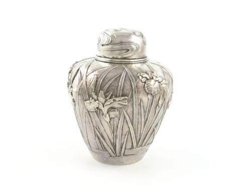 A Japanese silver tea caddy, marked to the base with Japanese characters, tapering circular form, embossed with irises on a s
