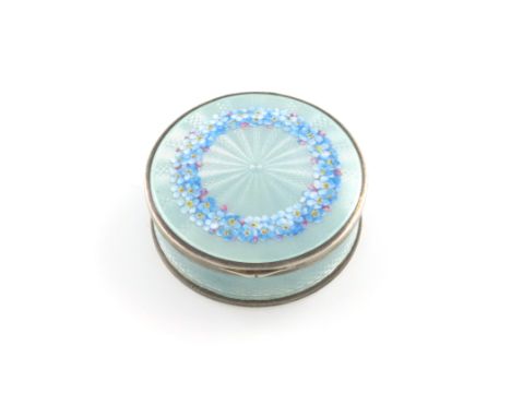 A German silver and enamel box, circular form, the cover decorated with a circular band of flowers on a light blue ground, di