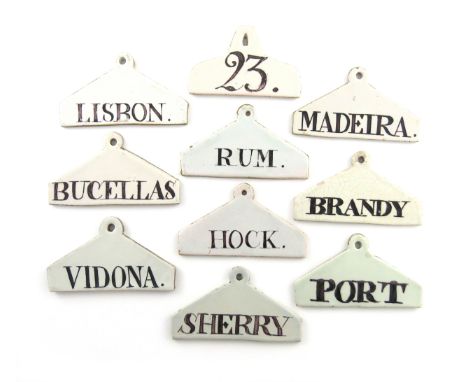 A collection of ten 18th and 19th century Delftware bin labels, coat hanger form, titled 'HOCK', 'LISBON', 'BRANDY', 'PORT', 