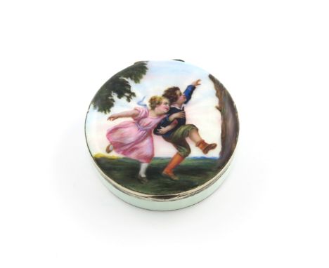 A German silver and enamel box, maker's mark E and W, circular form, the cover decorated with a playful boy and girl, in a la