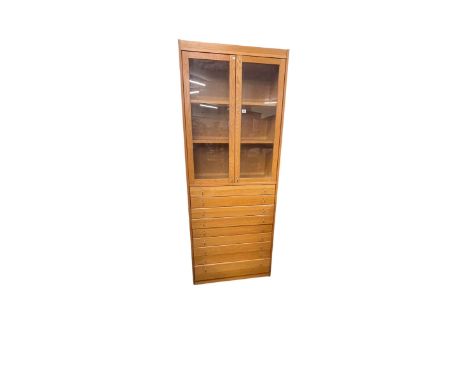 Light oak cabinet having two glazed panel doors above nine drawers, 202cm by 79cm by 35cm.
