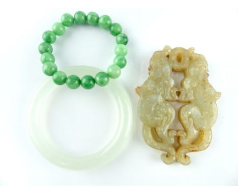 Chinese jade carving of two kylin, together with a bangle and a bead bracelet, (3)