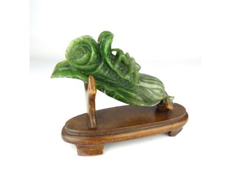 Chinese carved jade flower bud, modelled with an insect and mounted on a hardwood base, 13cm w