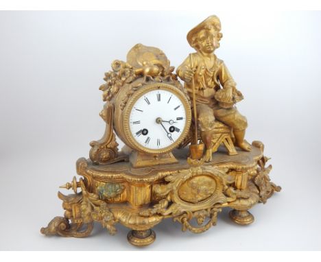 Late 19th century gilt metal mantel clock, modelled with a young gardener seated beside the movement, the white enamel dial s