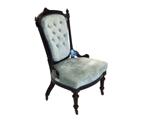 Ebonised button back nursing chair, upholstered in blue fabric, 85cm high. 