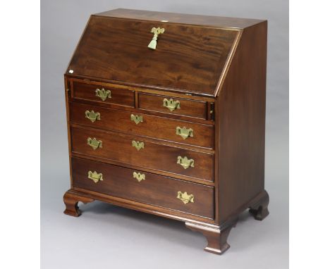A Georgian-style mahogany bureau with a fitted interior enclosed by a fall-front above two short &amp; three long graduated d