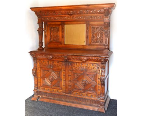 A Victorian carved oak mirror-back sideboard with caryatide supports, fitted two frieze drawers above a small cupboard &amp; 