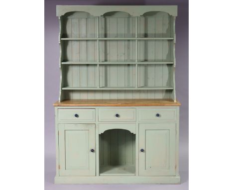 A light-green painted &amp; natural pine dresser, the upper part with three open shelves with a panelled back, the base fitte