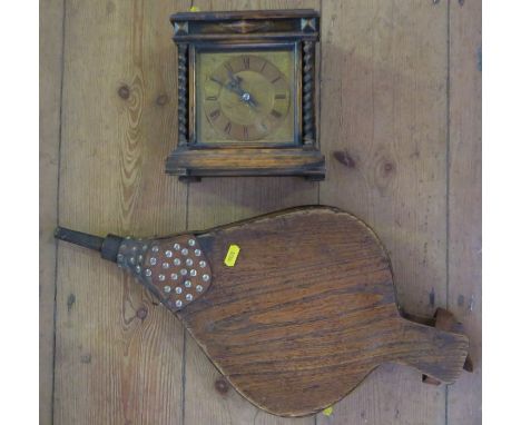 An oak cased mantel clock, with brass dial, height 7.5ins, together with a pair of oak bellows
