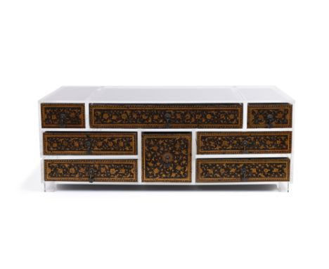A SAFAVID-STYLE GILT AND LACQUERED INDIAN PORTABLE CHEST OF DRAWERSMughal India, 17th century
Comprising eight carved ebony n