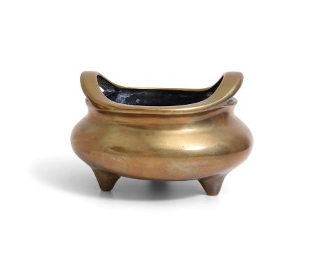 A BRONZE INCENSE BURNERChina, Qing dynasty, 18th / 19th century
With a compressed circular body supported on three tapered fe