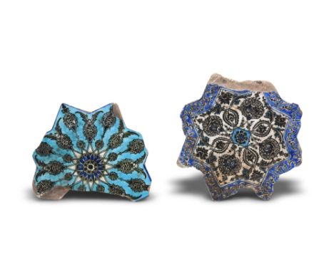 TWO FRAGMENTARY BLACK-PAINTED STAR-SHAPED POTTERY TILESSafavid Iran, circa 1600
Each designed in the shape of an eight-pointe