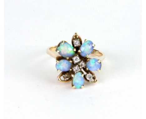 An opal and diamond flowerhead cluster ring, claw-set with five opals and six diamonds in a stylised design, stamped '18K', s