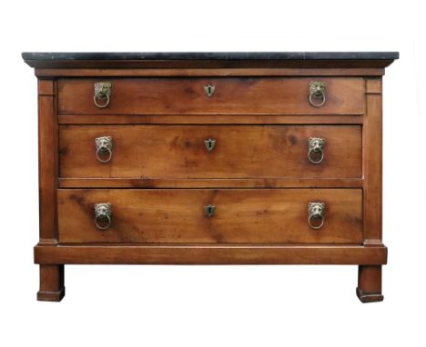 A French provincial walnut commode, early 19th century, the rectangular black veined marble top above three long drawers, fla