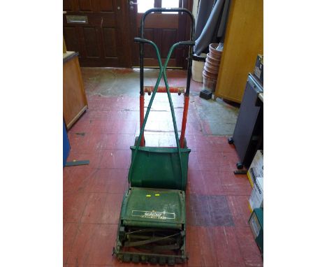 Manual Qualcast Panther 30S lawnmower and a red and black sack trolley