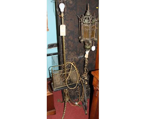An early 20th century spiral turned brass standard lamp, with integral central magazine rack; together with a Gothic Revival 