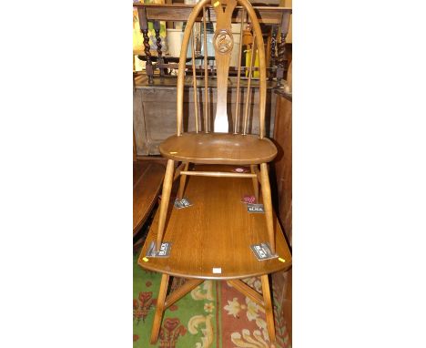 An Ercol mid-elm dining suite, comprising; dropflap table and four swan-back dining chairs (5)