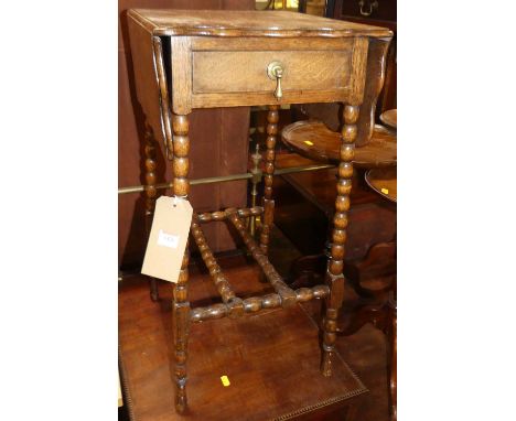 An early 20th century oak dropflap single drawer occasional table, on bobbin turned supports, w.33cm (leaves down)
