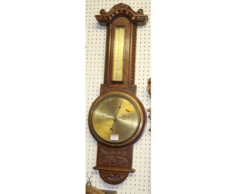 A relief carved oak two-dial wheel barometer