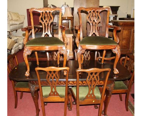 A mahogany round cornered extending dining table, having pull-out action and single extra drop-in leaf, on acanthus leaf carv
