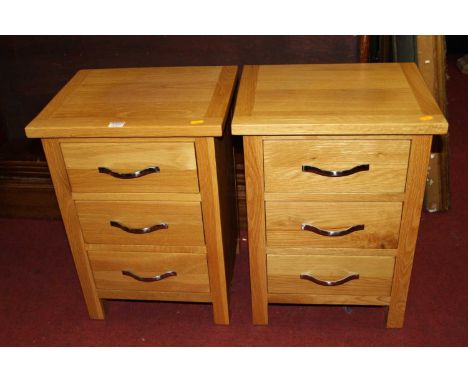 A pair of contemporary light oak three-drawer bedside chests, width 42cm