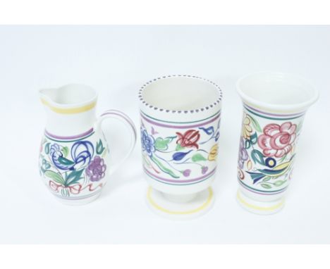 Three pieces of Poole pottery to include a vase on a pedestal base, flared vase and a jug