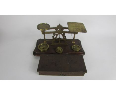 A set of 20th century postal weighing scales, stamped John Heath, Birmingham on mahogany base, with various weights and one s