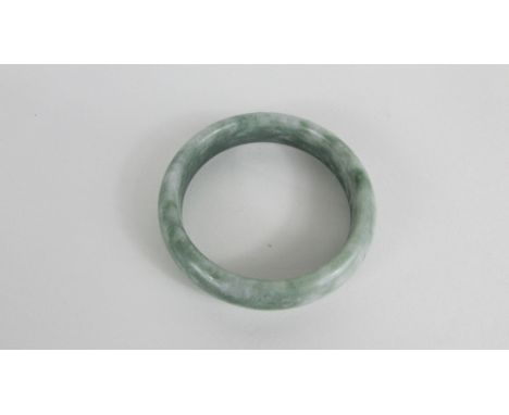 A green Chinese hard stone bangle