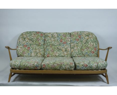 An Ercol beech and elm two seater sofa