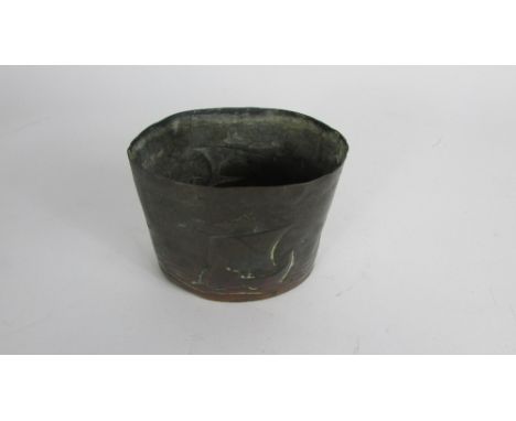 A Newlyn copper tea caddy, of oval form, decorated with two sailing ships at sea, impressed mark, lacking cover, height 8.2 c