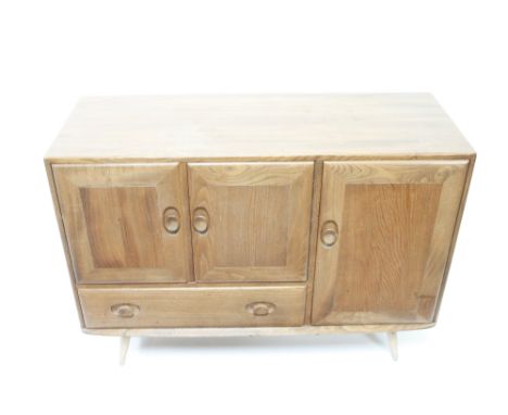 An Ercol elm sideboard with three door cupboard section and one single long drawer,81cm high, 114cm long, 43cm deep