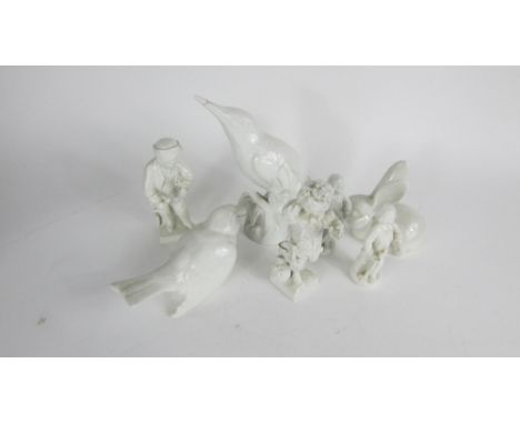 A Berlin ceramic model of a kingfisher, along a model of a rabbit, finch and four figures