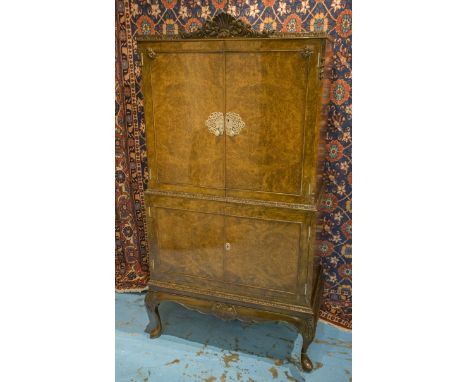 COCKTAIL CABINET, early 20th century Queen Anne style, burr walnut with two doors, enclosing lit mirrored interior on carved 