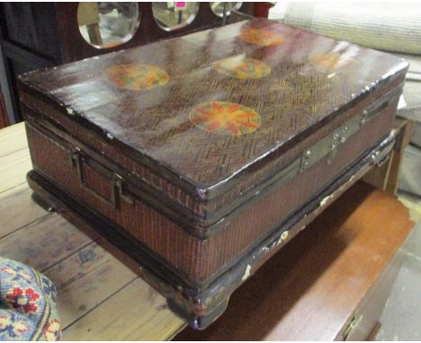 ORIENTAL TRUNK, lacquered, gold patterned and rattan, the rectangular rising top with floral decoration and carrying handles 