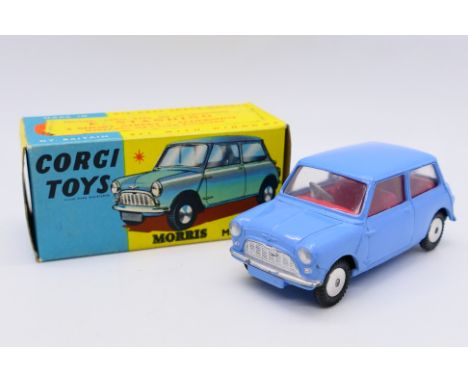 Corgi - A boxed Corgi Morris Mini Minor in blue with a red interior and smooth wheel hubs # 226. The car appears in Near Mint
