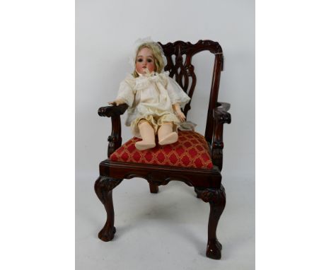 Gebruder Kuhnlenz - An early 20th century Gebruder Kuhnlenz bisque headed doll with fixed brown glass eyes, open mouth with u