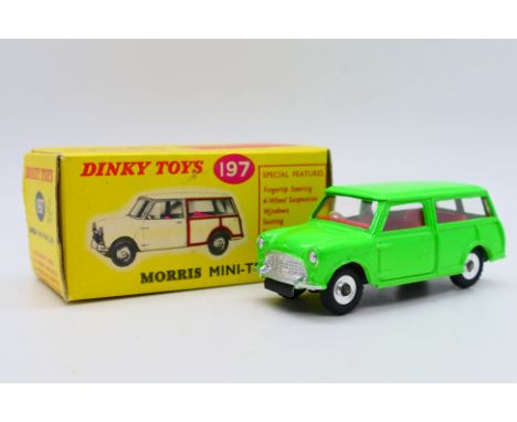 Dinky - A boxed Morris Mini Traveller in fluorescent green # 199. The car appears Mint, the box is Very Good with some light 