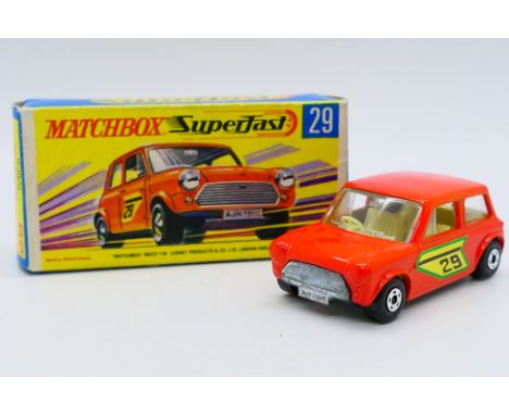 Matchbox - A boxed Racing Mini in orange with the rare green edged number stickers. The car appears in Mint condition in a Ne