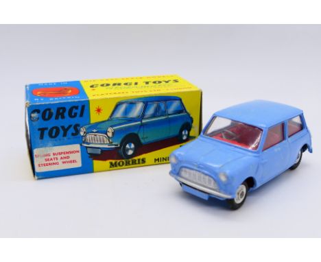 Corgi - A boxed Morris Mini Minor in blue with red interior and shaped wheel hubs # 226. The car appears in Mint condition, t