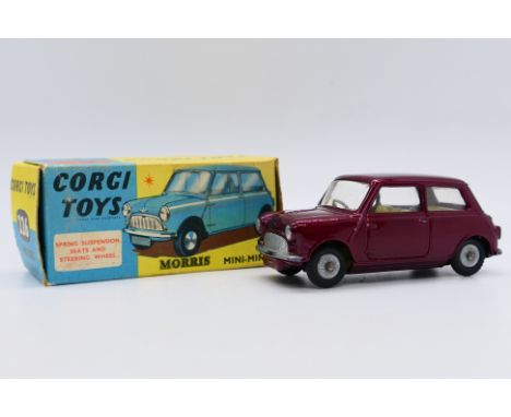 Corgi - A boxed Corgi Morris Mini Minor in metallic red # 226. The car appears in Near Mint condition with some light rubbing