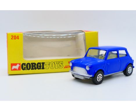 Corgi - A boxed Morris Mini Minor in blue # 204. The car appears in Mint condition, of note is the fact that the paint finish